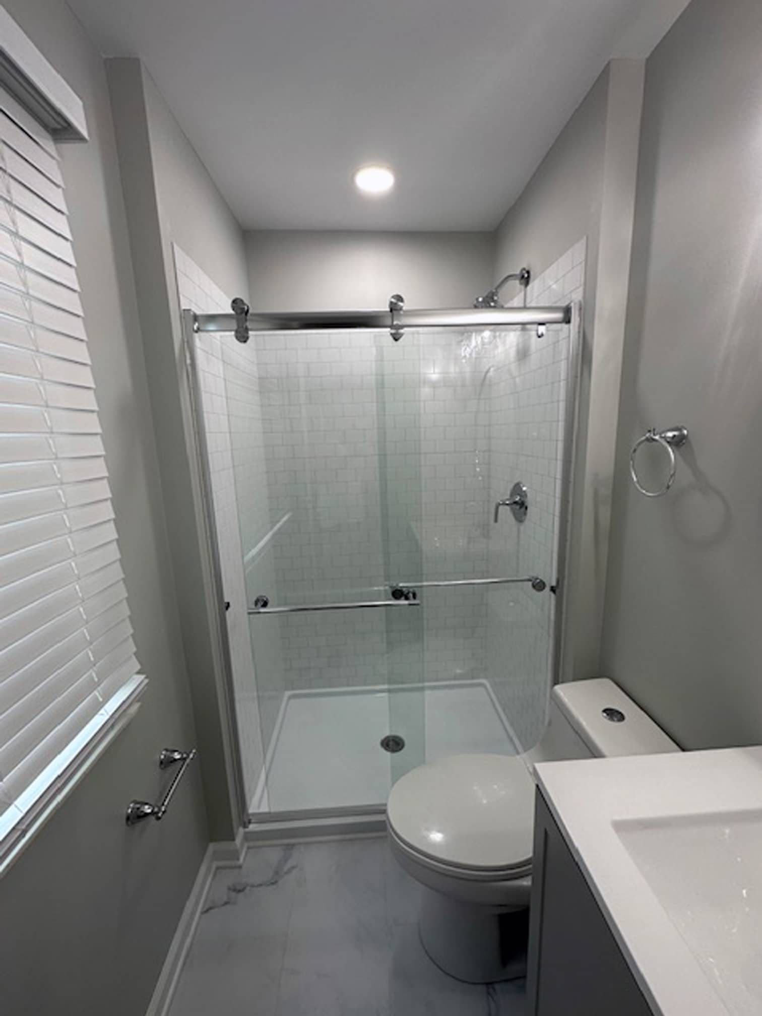 Modern bathroom with glass shower enclosure and vanity in a Dublin, OH property