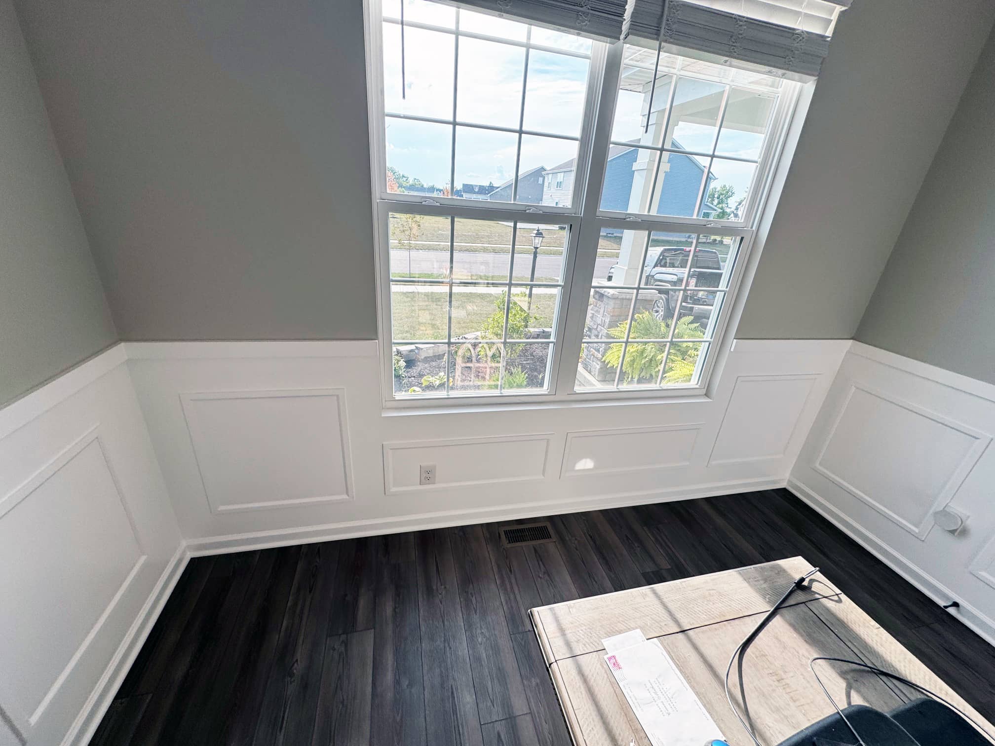 Bright room with large windows and dark hardwood flooring in a Worthington, OH home
