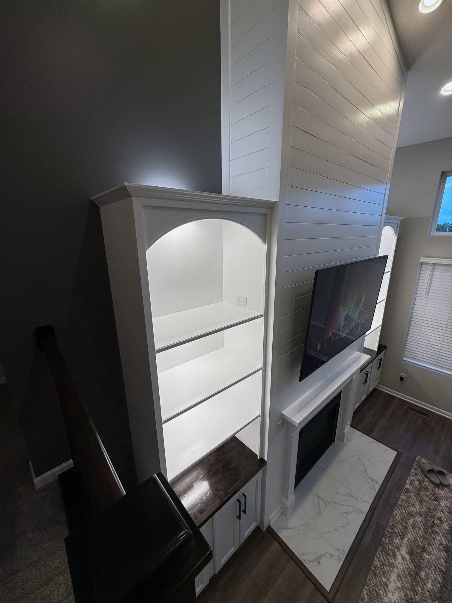 Entertainment wall with built-in shelving in a Hilliard, OH living room project