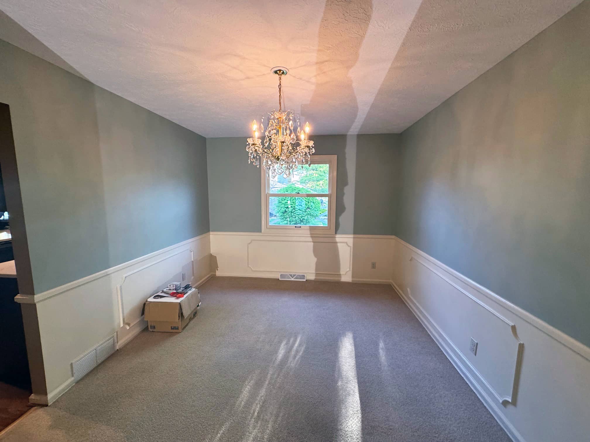 Empty formal room with chandelier and carpet in a Dublin, OH residence