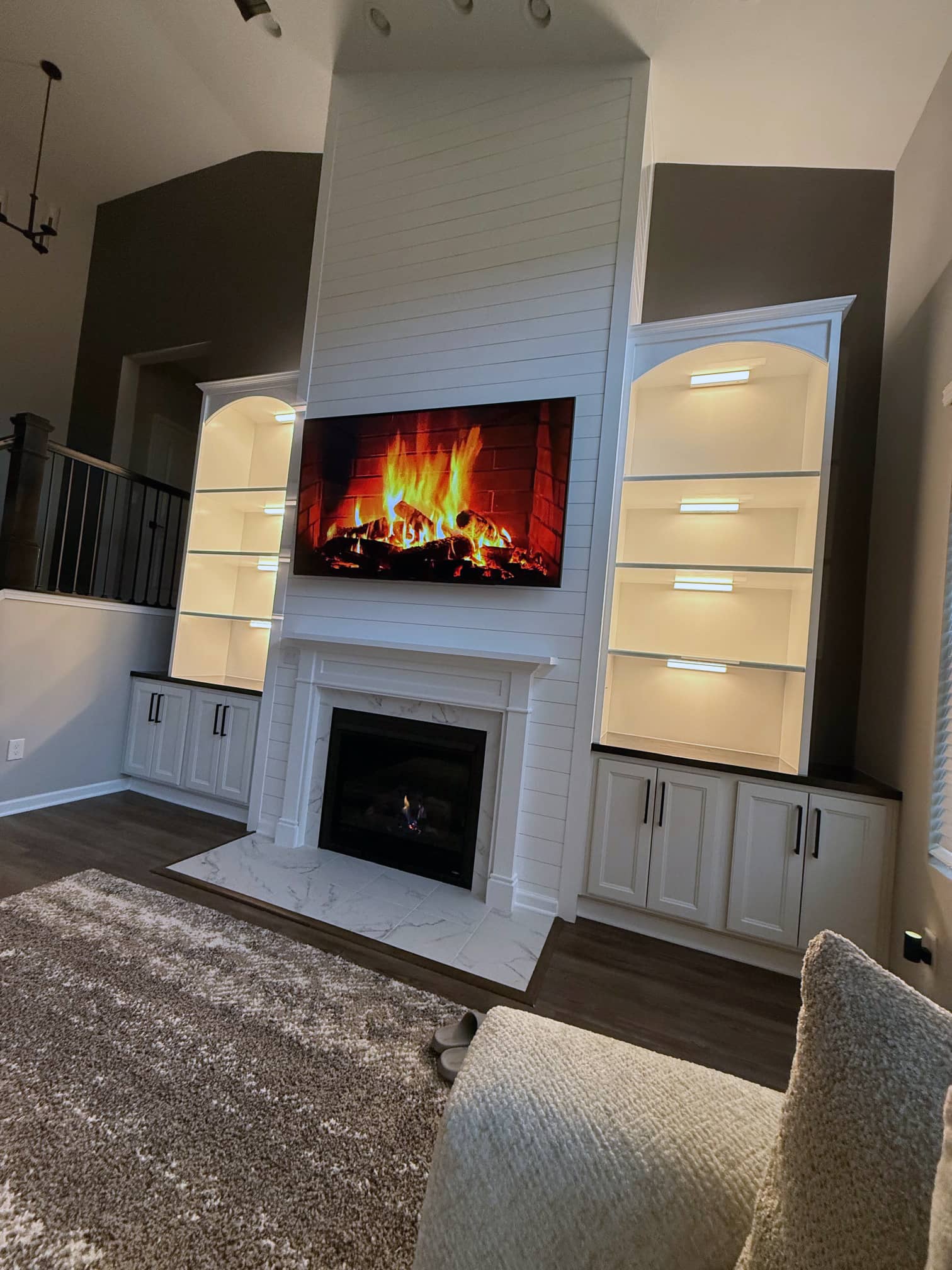 Living room with modern fireplace and built-in shelving in a Powell, OH property