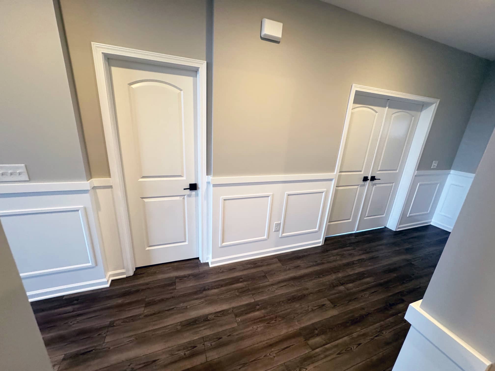 Empty interior room with dark wood floors and neutral gray walls in Westerville, OH