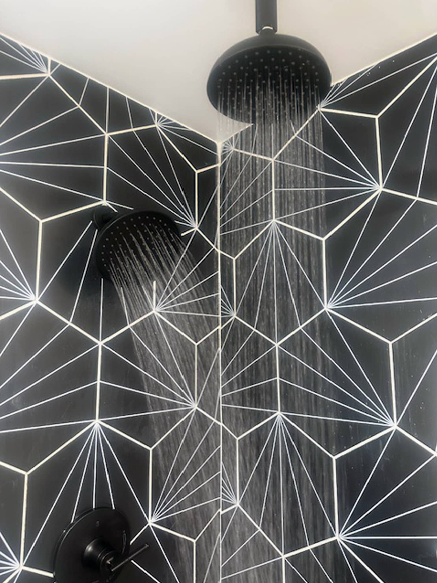 Close-up of modern shower featuring dramatic geometric tile in a Columbus, OH area bathroom