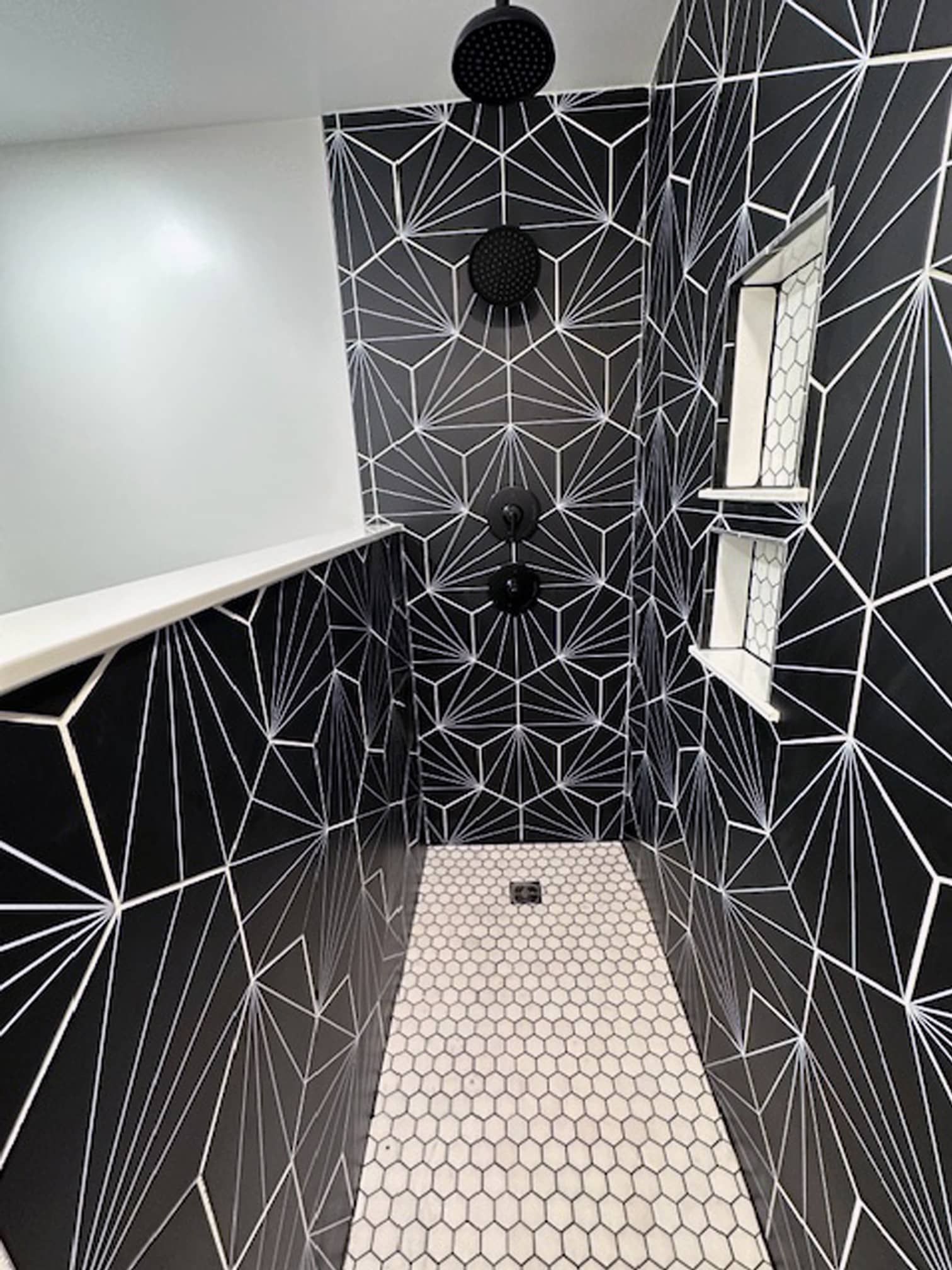 Contemporary shower with patterned black tile and rainfall showerhead in Gahanna, OH