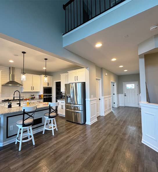 open concept kitchen remodel with white cabinets and granite island in Powell, Ohio