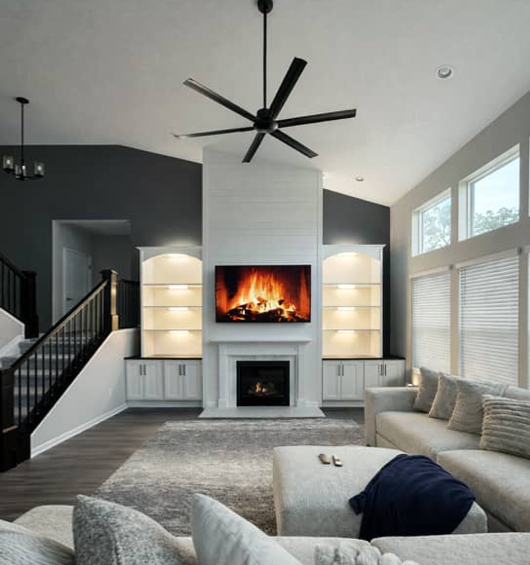 fireplace with custom woodwork and built-in shelving